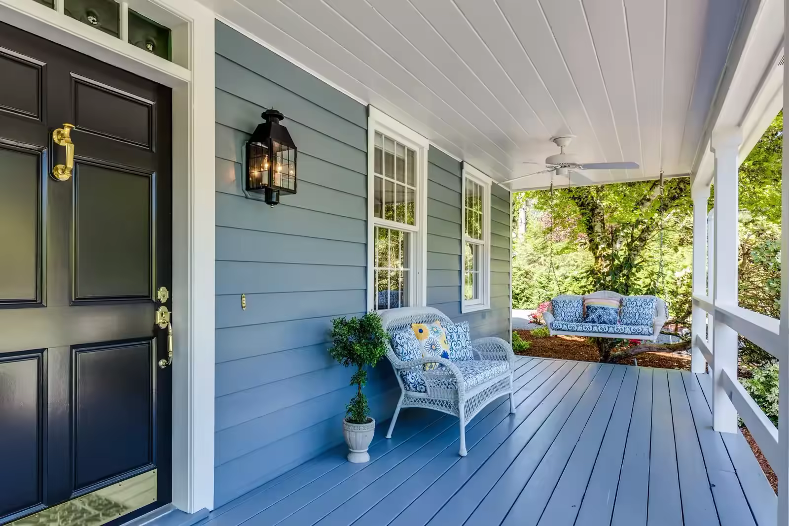 Freshly painted home verandah with weatherboard cladding and timber-lined ceiling
