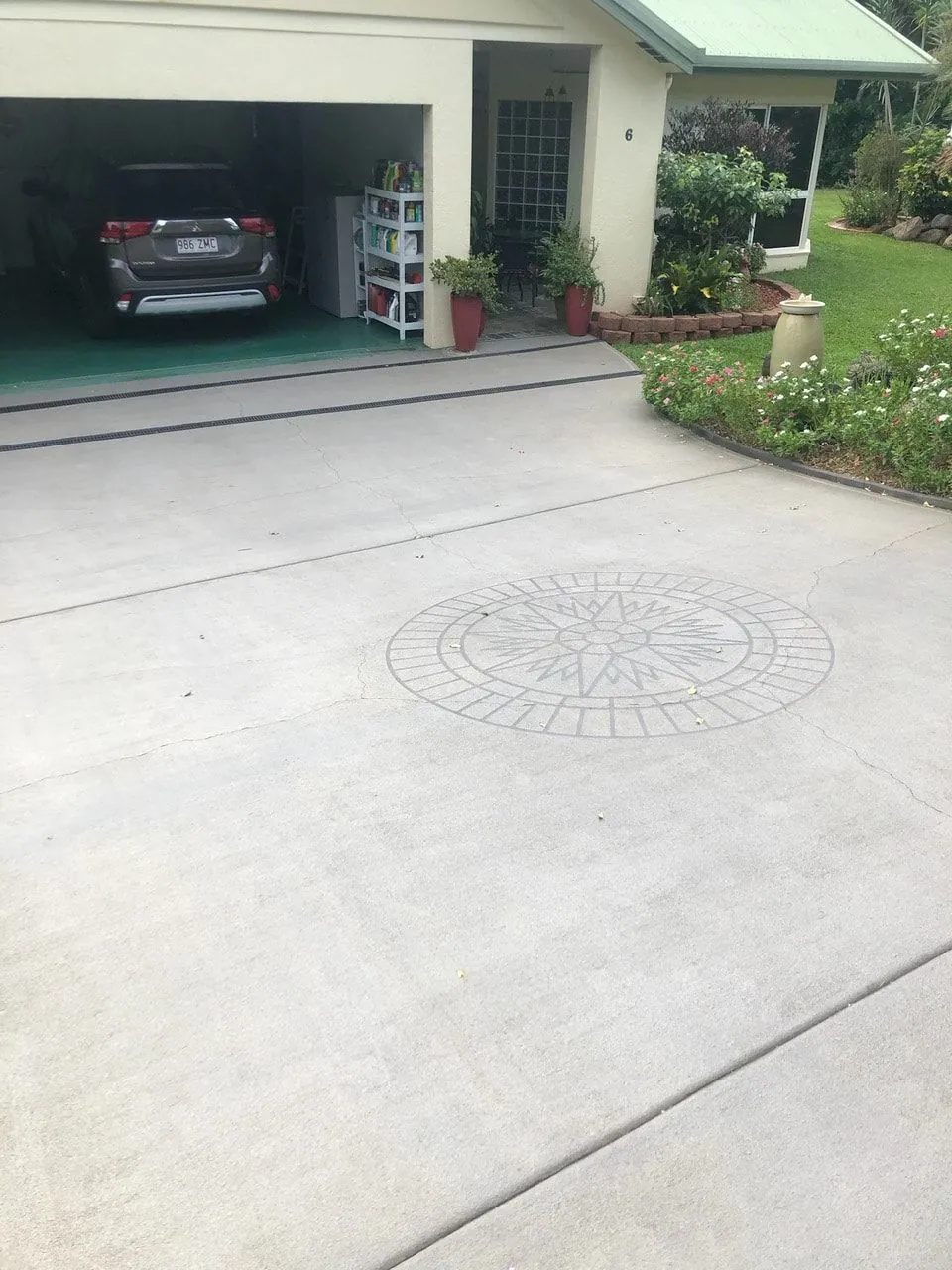 Cairns concrete driveway with a decorative painted finish and stencilled centrepiece